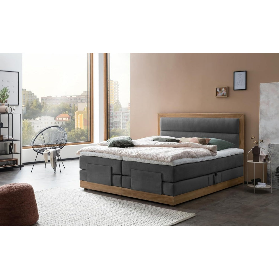 Das Boxspringbett setzt auf eine Farbgebung in Anthrazit